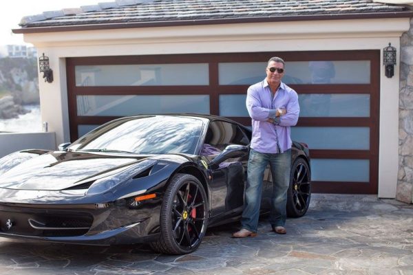 Caption :Ed Mylett with his car