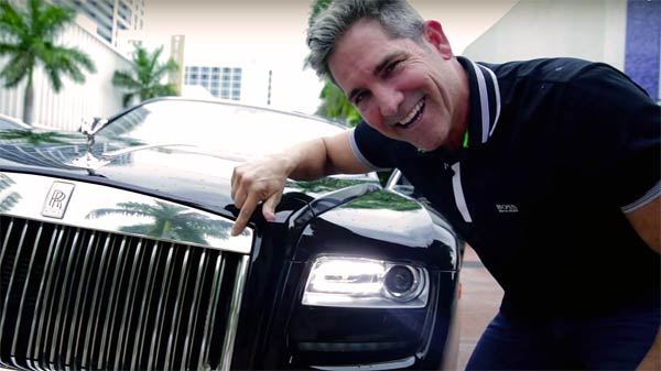 Grant Cardone clicking photo with his car