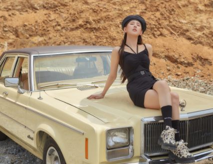 Cho Mi-Yeon posing for a photo with a car 