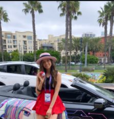 Caption : Pokimane posing for the photo with her car