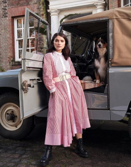 Eve Hewson posing for a photo with a car