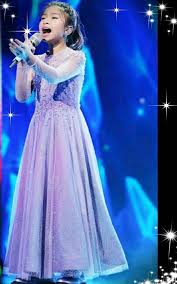 Caption: Celine Tam singing a song infornt of mass
