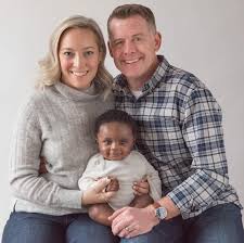 Caption :Doyle Devereux withhis wife Meredith Merz and son