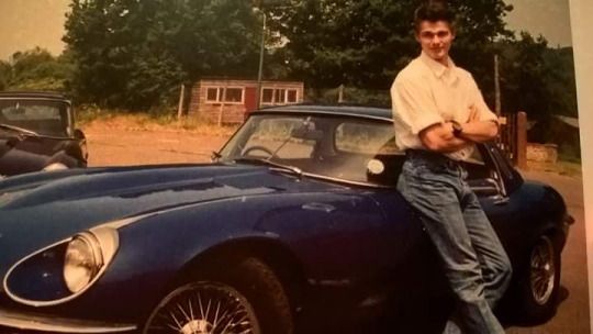 Morten Harket posing in front of his car