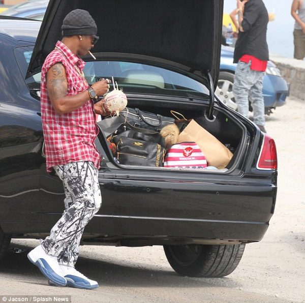 Katt Williams standing outside his car
