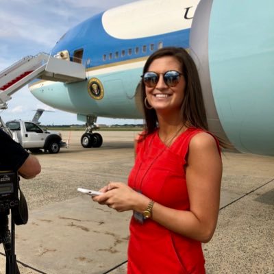 Kaitlan Collins posing for the photo with plane