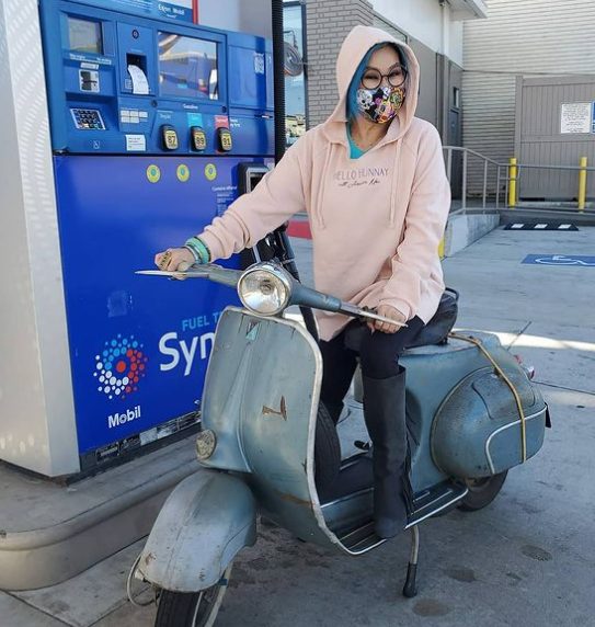 Olivia TuTram Mai posing for a photo with her scooter