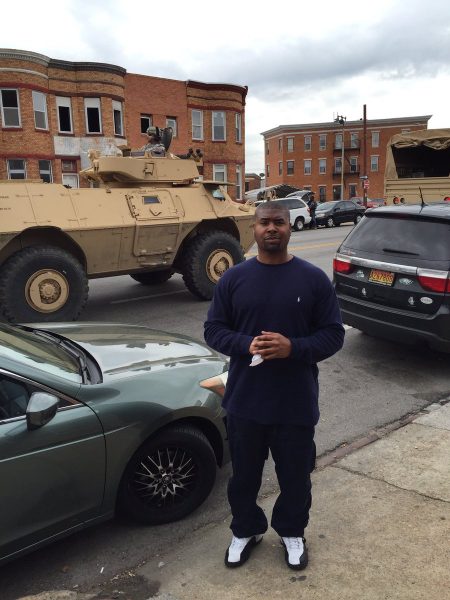 Tariq Nasheed posing for a photo with his car