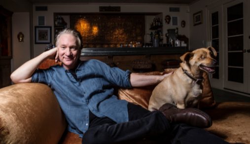 Bill Maher clicking photo with his dog