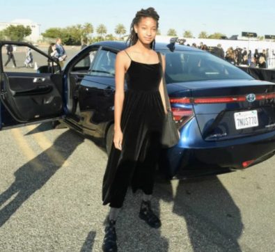 Willow Smith posing for a photo with her car