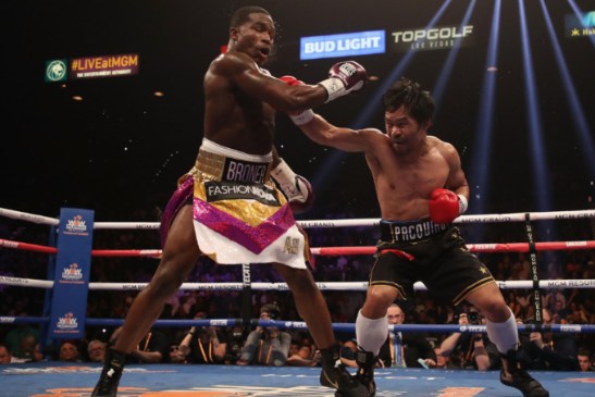 Adrien Broner and Manny Pacquiao fighting inside the ring