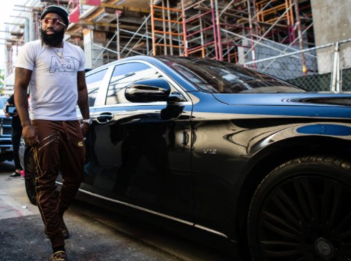 Adrien Broner posing with his car