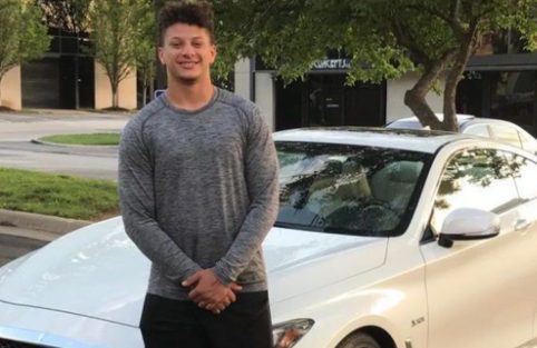 Mia Randall half-brother Patrick Lavon Mahomes II posing for a photo with his car