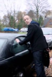 Caption:Kevin Eldon posing for the photo with his car