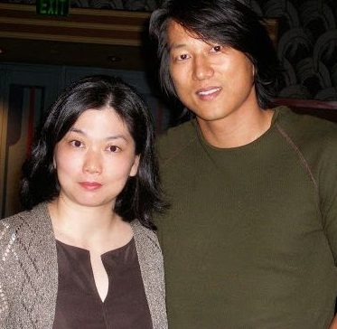 Sung Kang posing for a photo with his lovely wife Prada Miki Yim