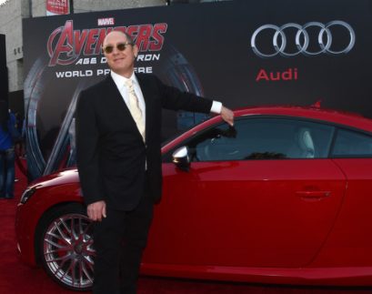James Spader posing for a photo with his car 