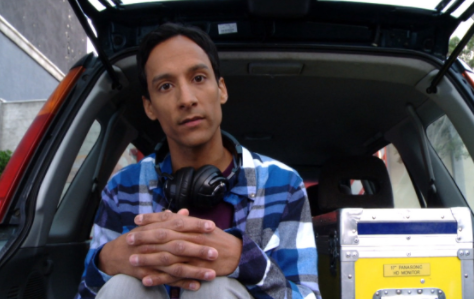 Danny Pudi sitting inside the car