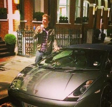 Josh Temple posing for a photo with his car 