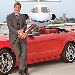  Troy Aikman posing for a photo with his car