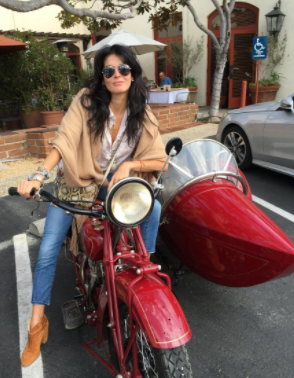 Angela Michelle Harmon posing for a photo with her bike