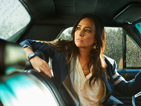 Pamela Adlon sitting inside the car