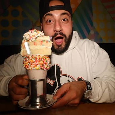 Moe Sargi posing for a photo with ice-cream