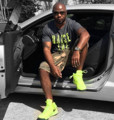 Jay Williams posing for a photo with car