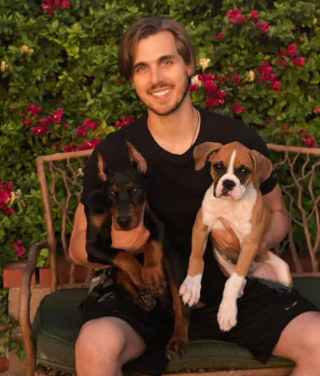 Cody Linley posing for a photo with dog