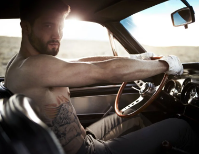 Carlos Condit posing for a photo with his car