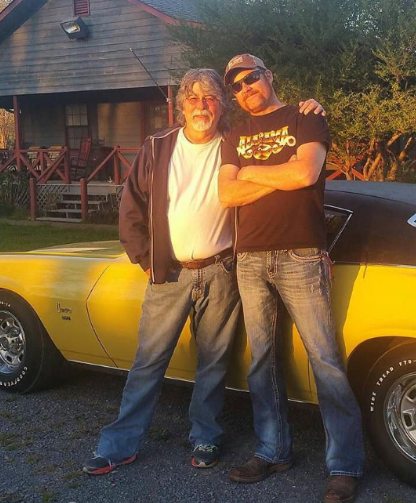 Alison Sena Yeuell's father, Randy Owen and his friend posing with his car