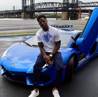 Atoya Burleson's husband Nate Burleson posing with his car