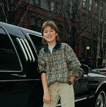 Corey Sevier posing with his car