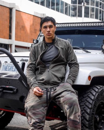 Damian Romeo posing with his jeep