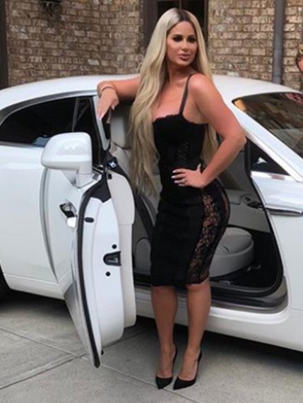 Daniel Toce's ex-wife, Kim Zolciak-Biermann posing with her car