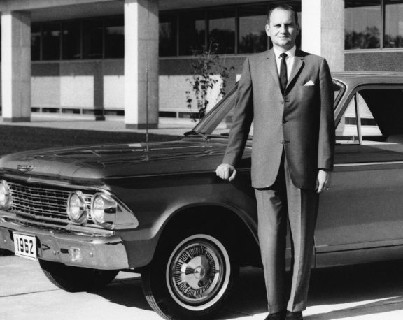 Darrien Earle's late ex-husband, Lee Iacocca posing with his car