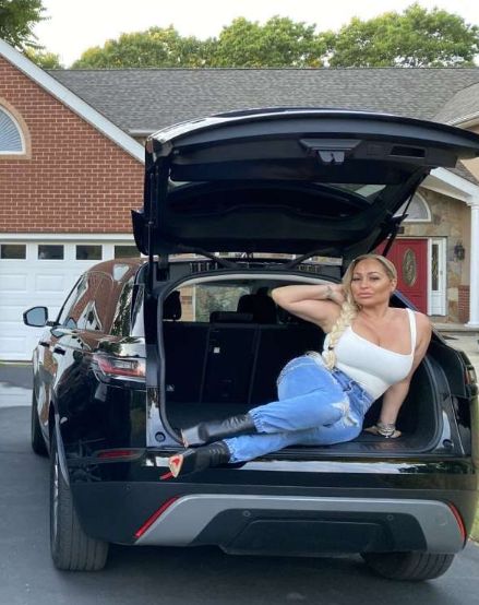 Frank Bollok's ex-wife, Darcey Silva posing with her car