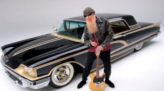 Gilligan Stillwater's husband, Billy Gibbons posing with his expensive car
