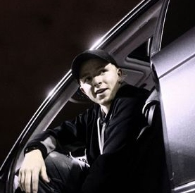 Jacob Anderson posing inside his car