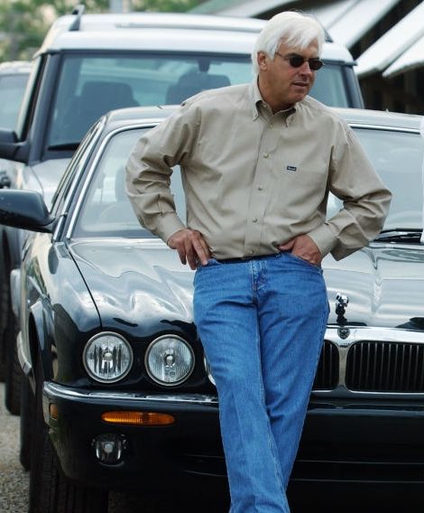 Jill Baffert's husband, Bob Baffert posing with his car