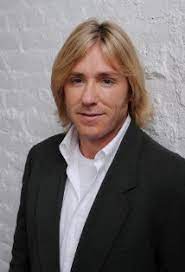 Ron Eldard posing for the photo