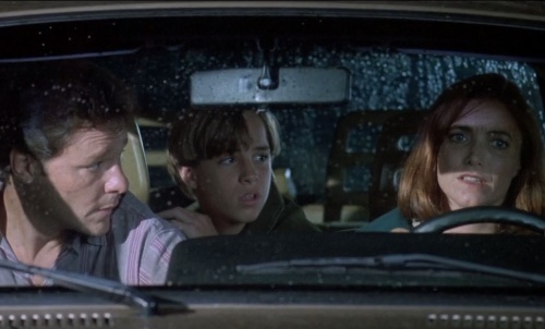 Karen Allen and her co-actors posing inside the car on the set of her movie