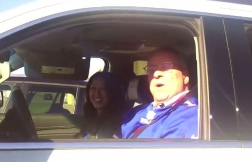 Kelly Pegula's parents posing from their car