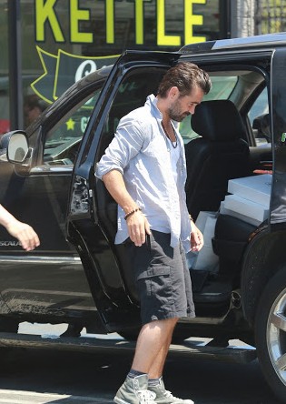 Kim Bordenave's ex-boyfriend, Colin Farrell posing with his car