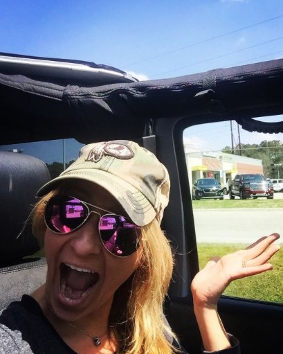 Lauryn Ricketts posing inside her jeep