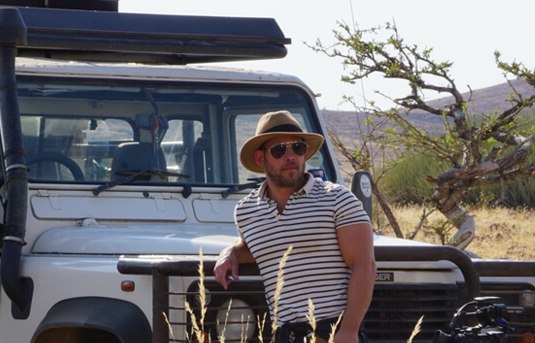 Sven Sundgaard posing with his jeep