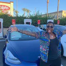 Gina Yashere posing for the photo with the car