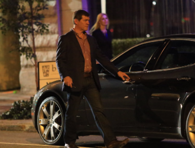 Matthew Glave standing outside his car