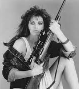 Denise Coward posing for a photo with gun