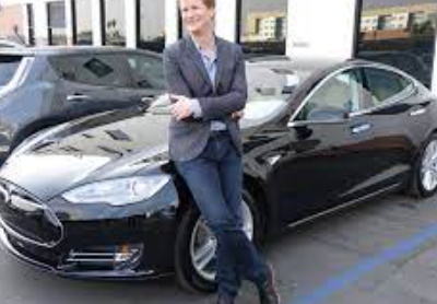 Jonathan Mangum posing for a photo with his car