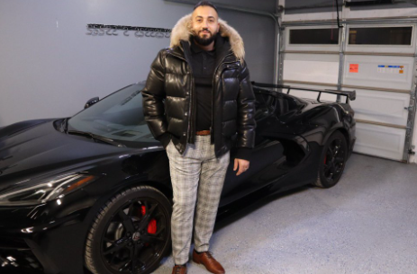 Moe Sargi posing for a photo with his car
